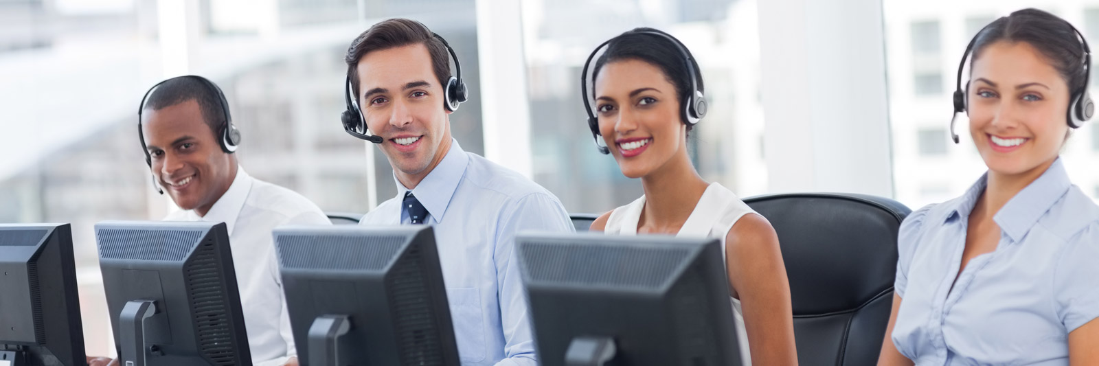 a group of young customer service representatives with headsets