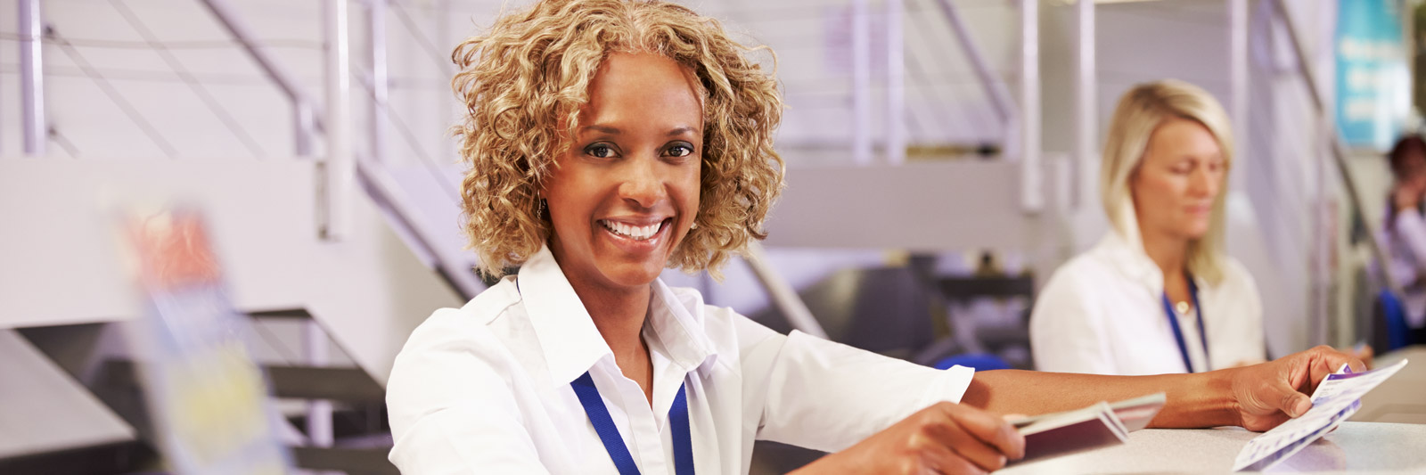 A lady at an airport check in desk